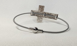 Silver colored hammered cross bracelet