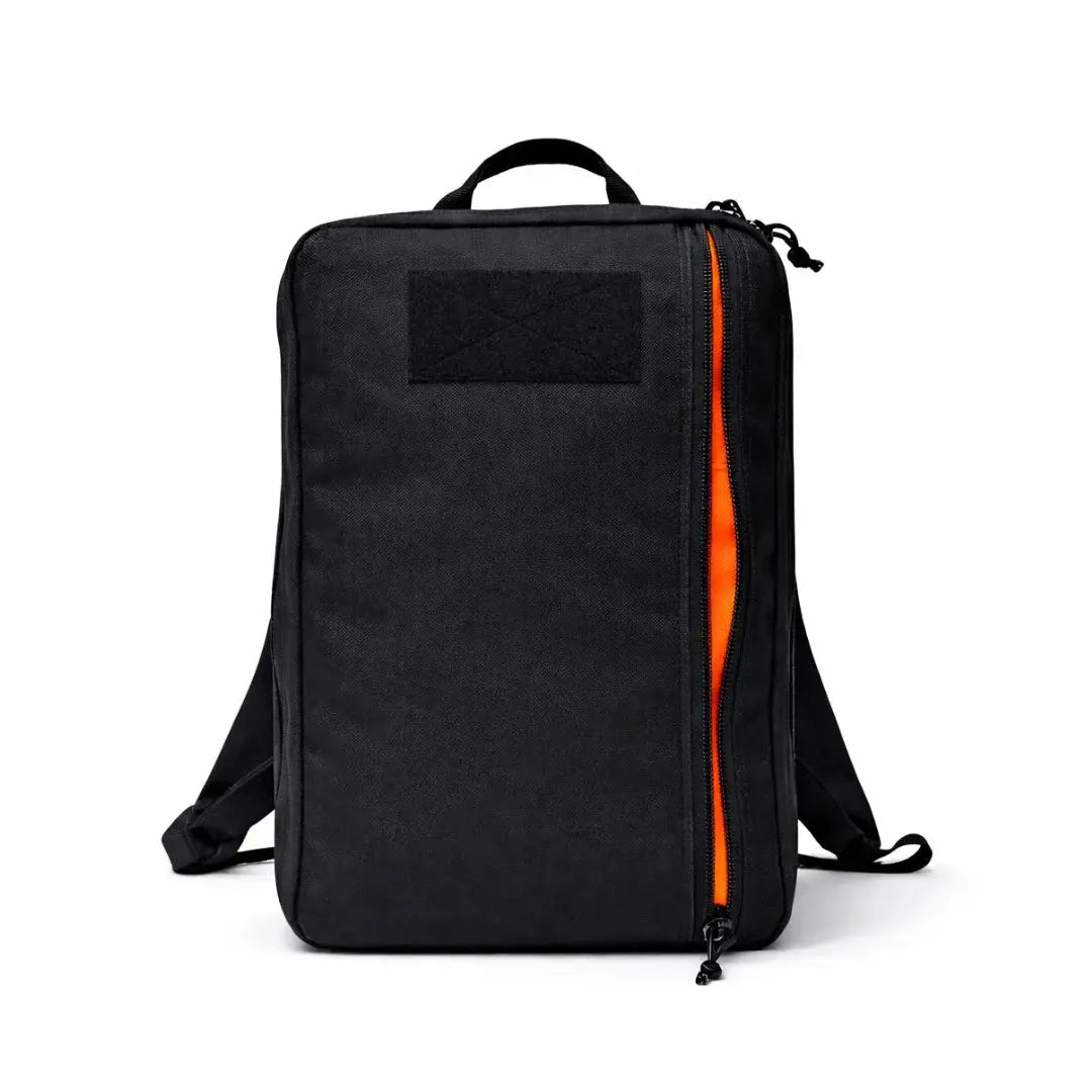Black backpack with an orange zipper opening and a patch on the front.