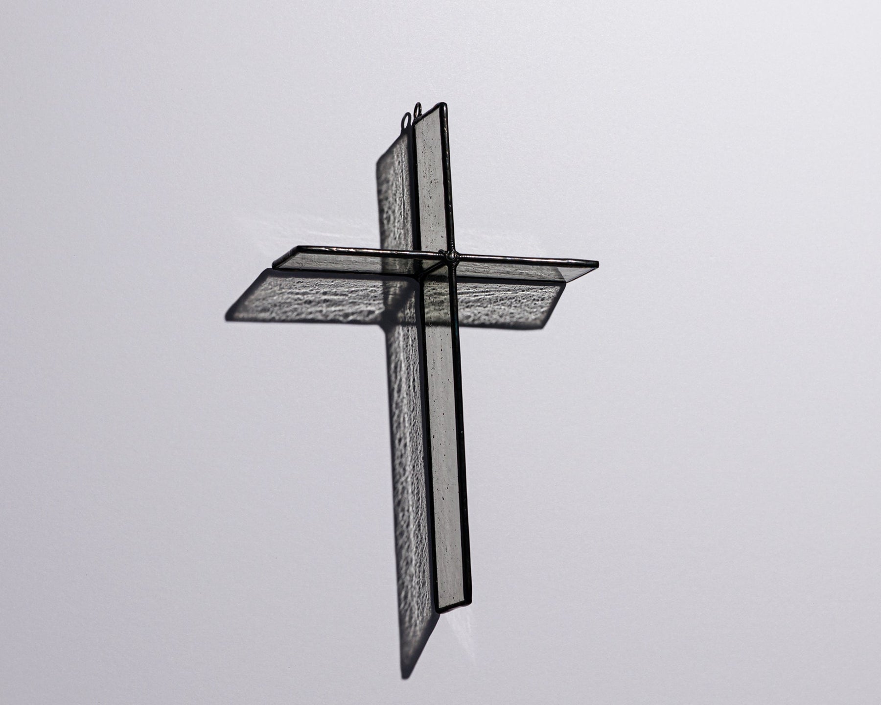 Alternate view of Cloud Grey Cross Suncatcher with real stained glass and black patina