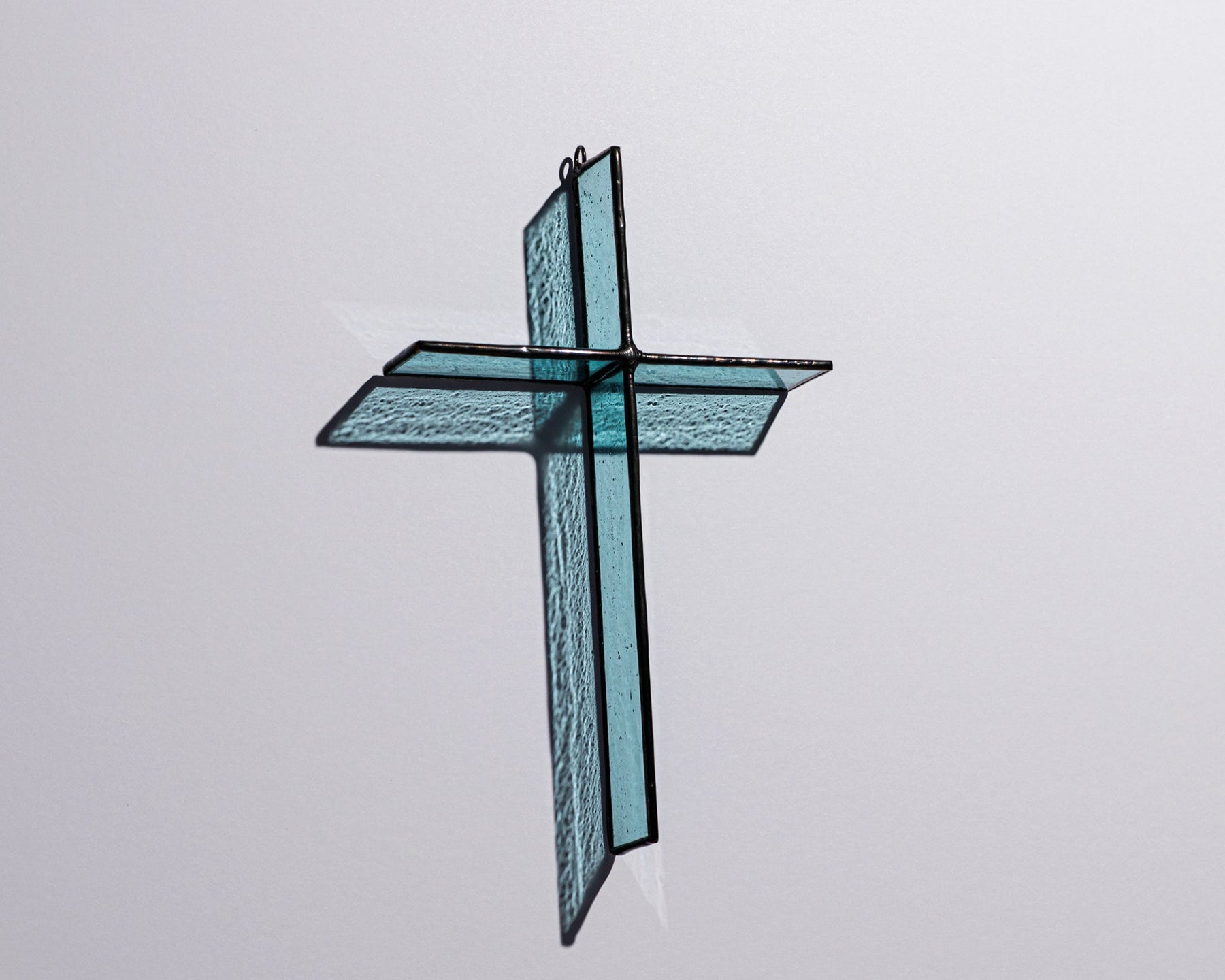 Alternate view of Pale Aqua Cross Suncatcher with real stained glass and black patina