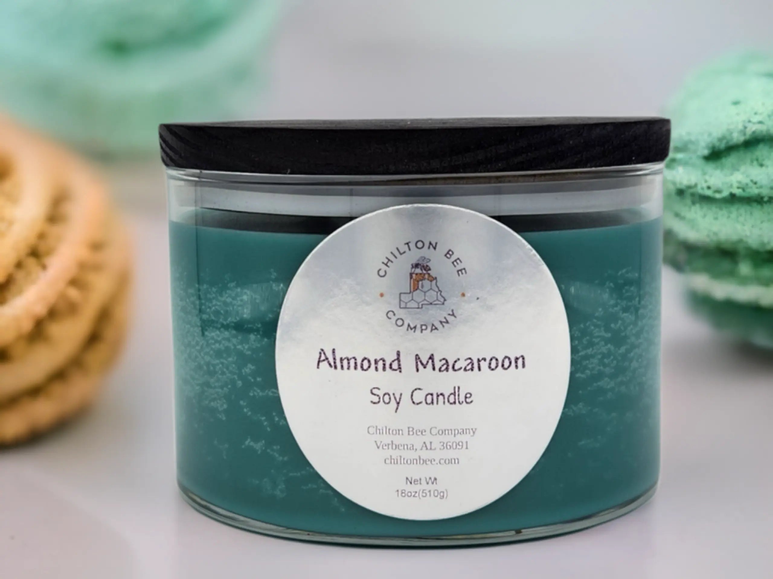 Teal soy candle in a clear glass jar with a black lid and "Chilton Bee Company" label.