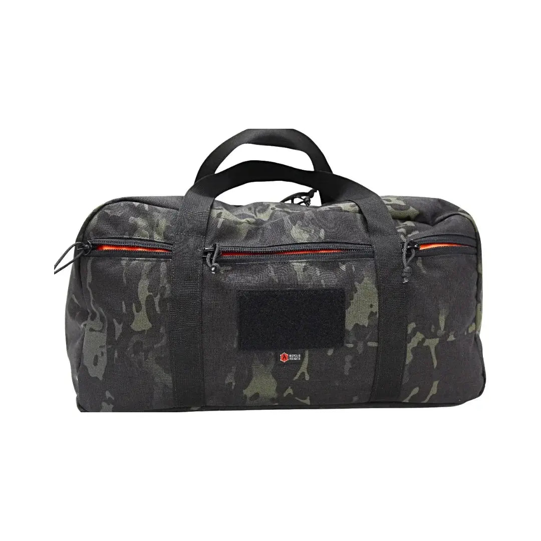 Camouflage duffle bag with orange zipper accents and black handles.