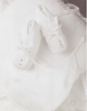 Personalized Baby Name Gift: White baby shoes and undershirt. Custom first name meaning keepsake by A & H Creative Names.