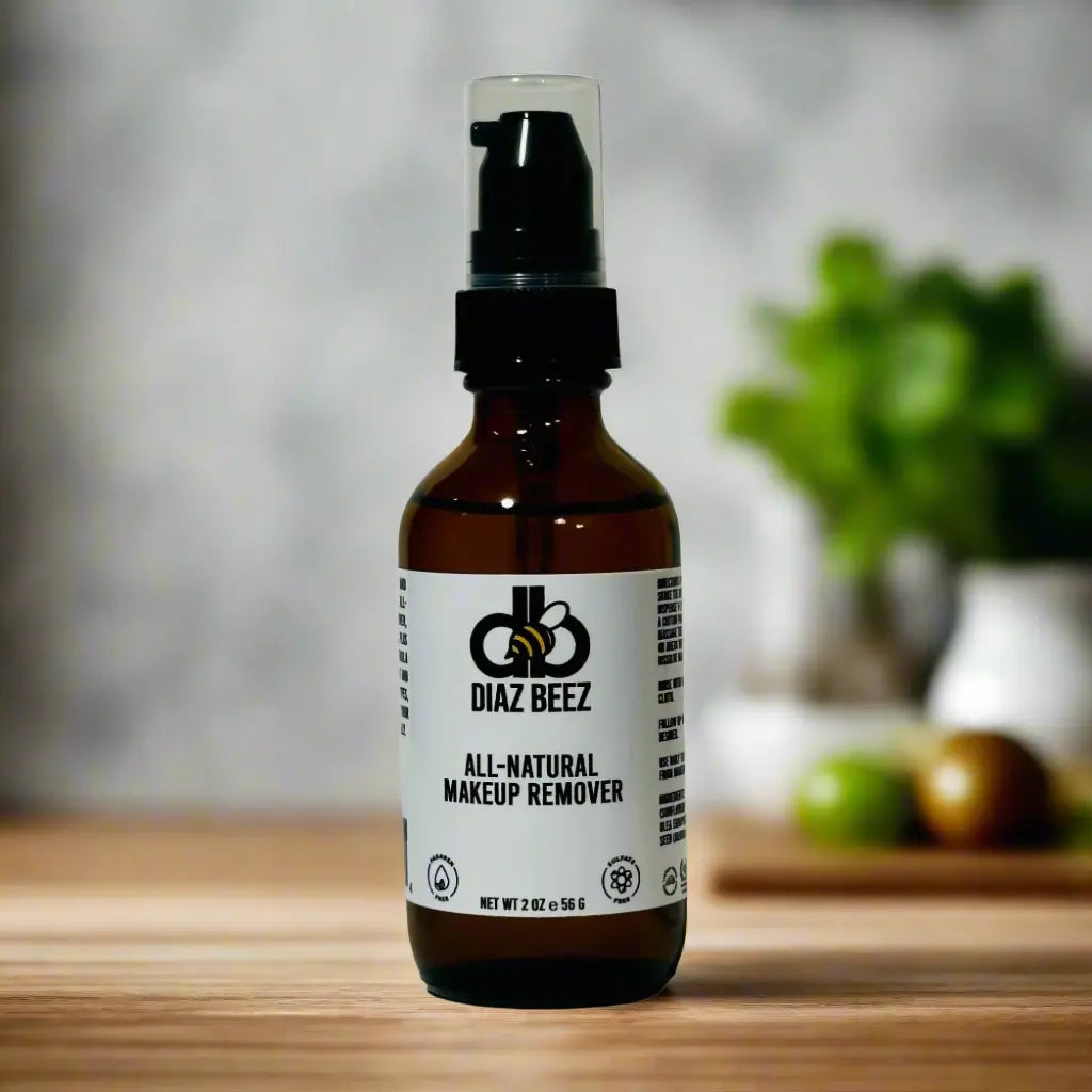 Diaz Beez All-Natural Makeup Remover in amber glass bottle with black pump dispenser on a wooden surface.