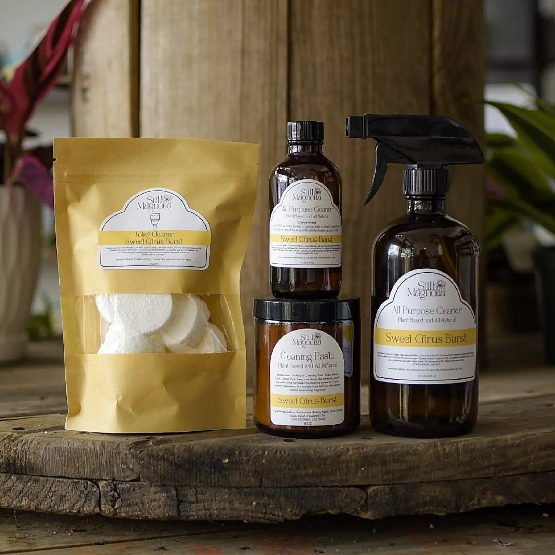 Still Magnolia cleaning products including spray bottles, cleaning paste, and toilet cleaner tablets.