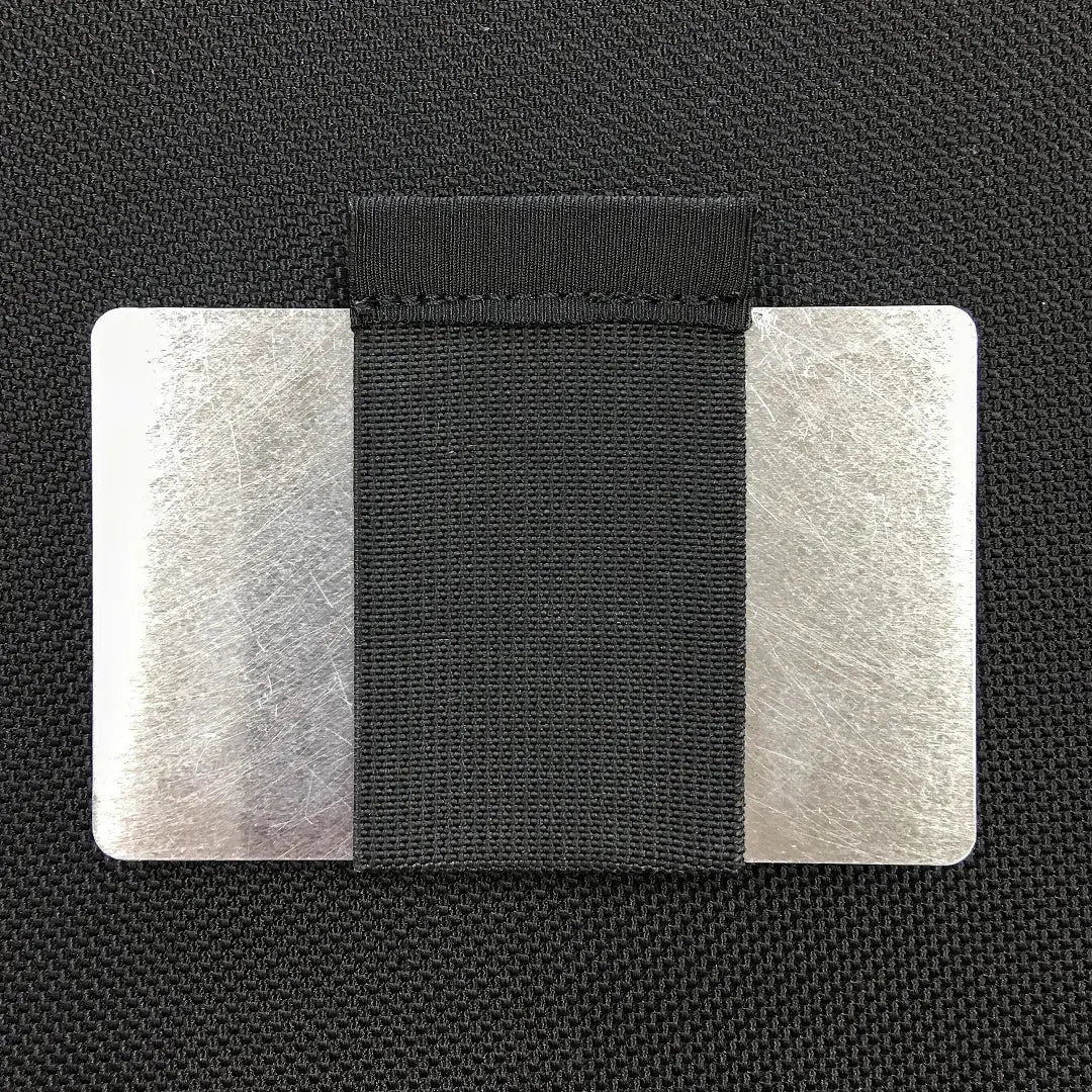 Two aluminum RFID blocker cards with a black fabric band.