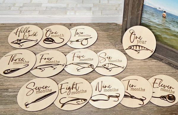 Baby milestone discs with fishing lure designs. Wooden photo props for baby's first year.