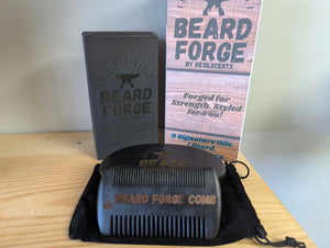 Beard Forge grooming set: box, beard comb, beard oil, brush and storage bag on wooden surface.