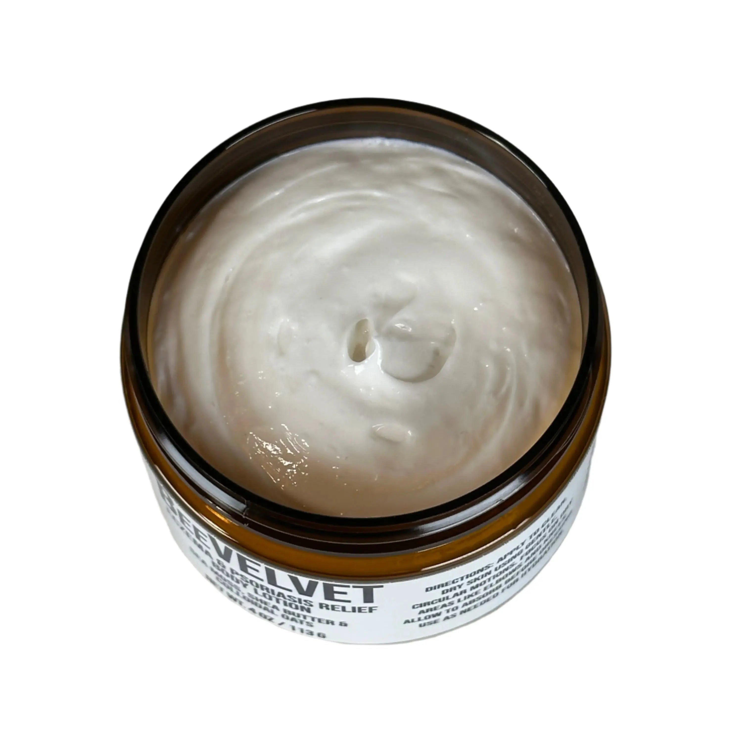 BeeVelvet eczema and psoriasis relief body lotion in a jar, showing lotion texture and visible product label.