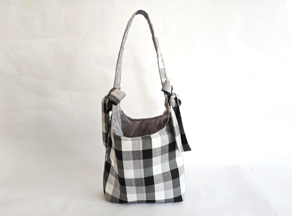 Black and white plaid tote bag with shoulder strap and tie detail. Handmade farmhouse style purse.