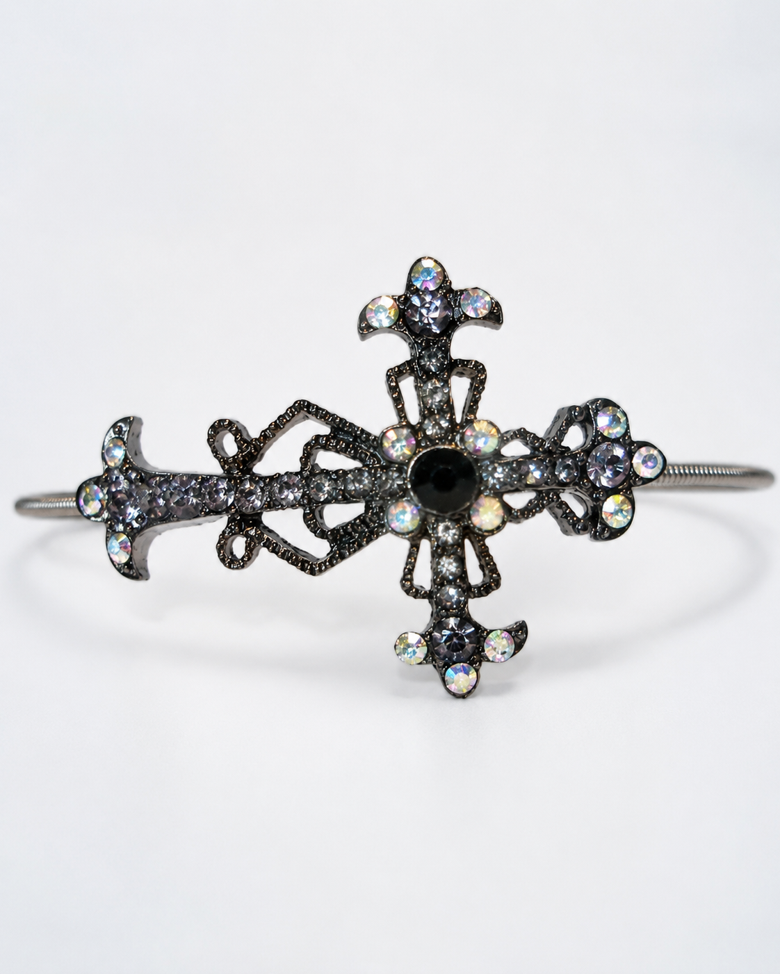Decorative cross-shaped bracelet with gemstones on a white background