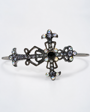 Decorative cross-shaped bracelet with gemstones on a white background