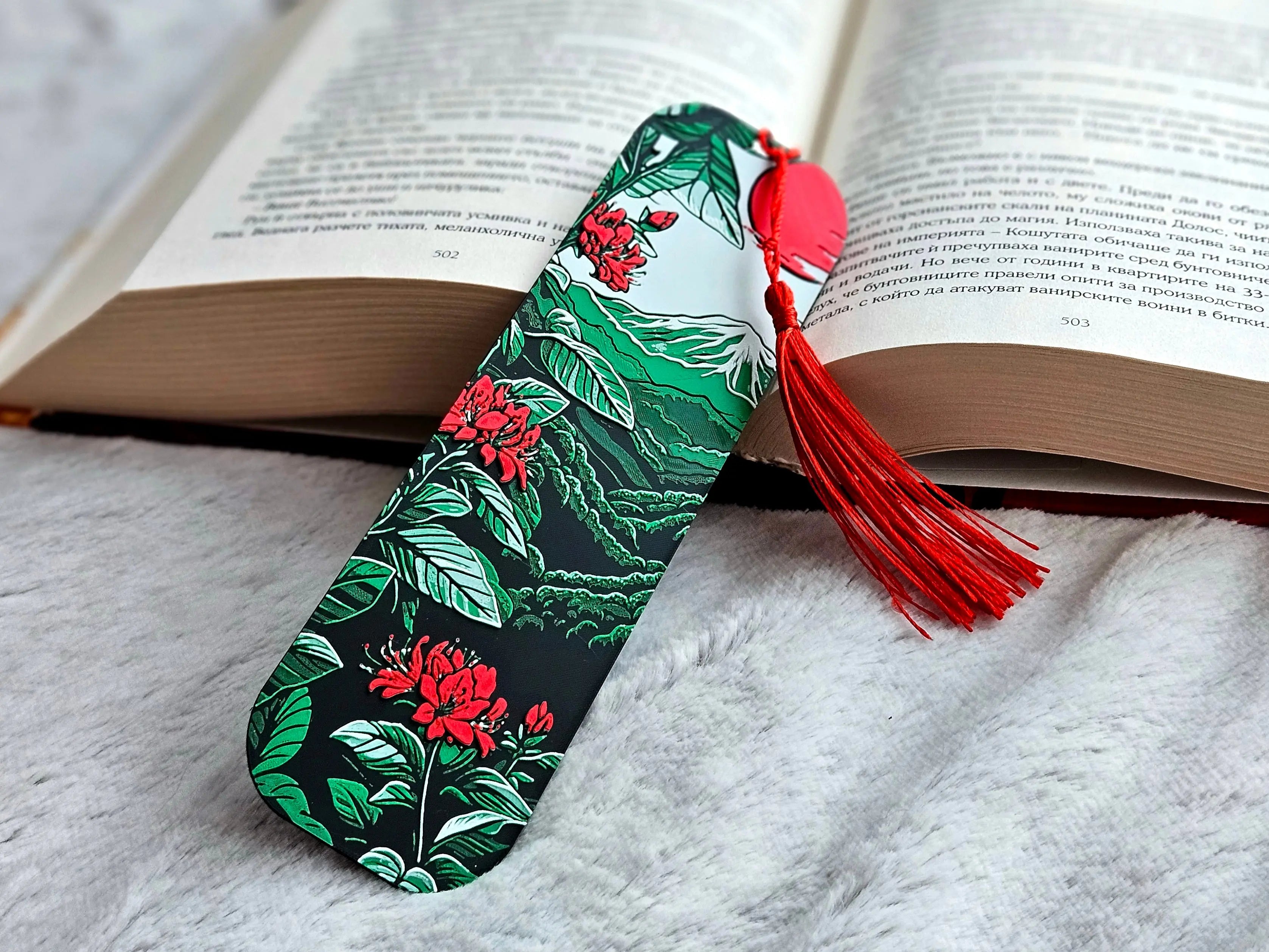 Mount Fuji bookmark with red tassel in open book; Japanese landscape design.