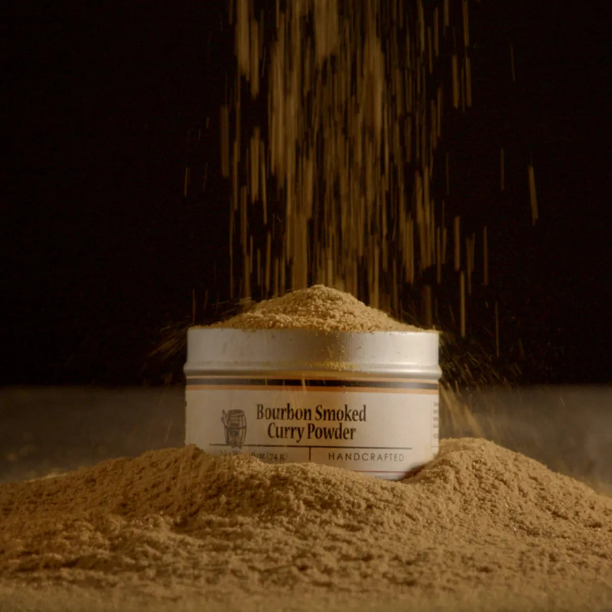 Bourbon Smoked Curry Powder in a tin canister with powder falling.