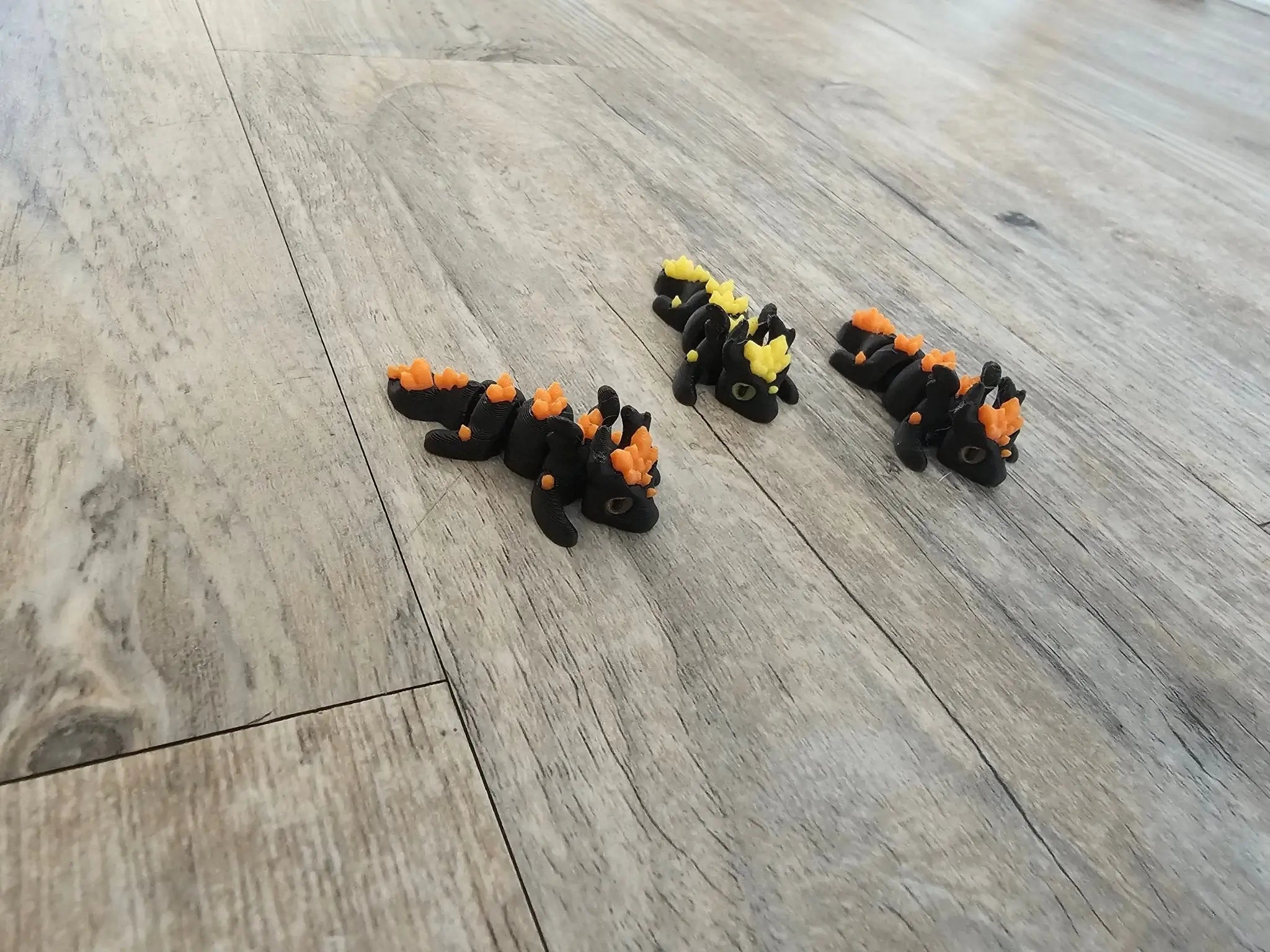 Main Street Collective's 3D printed fidget animals: black & orange dragons & lizards, fun & portable fidget toys