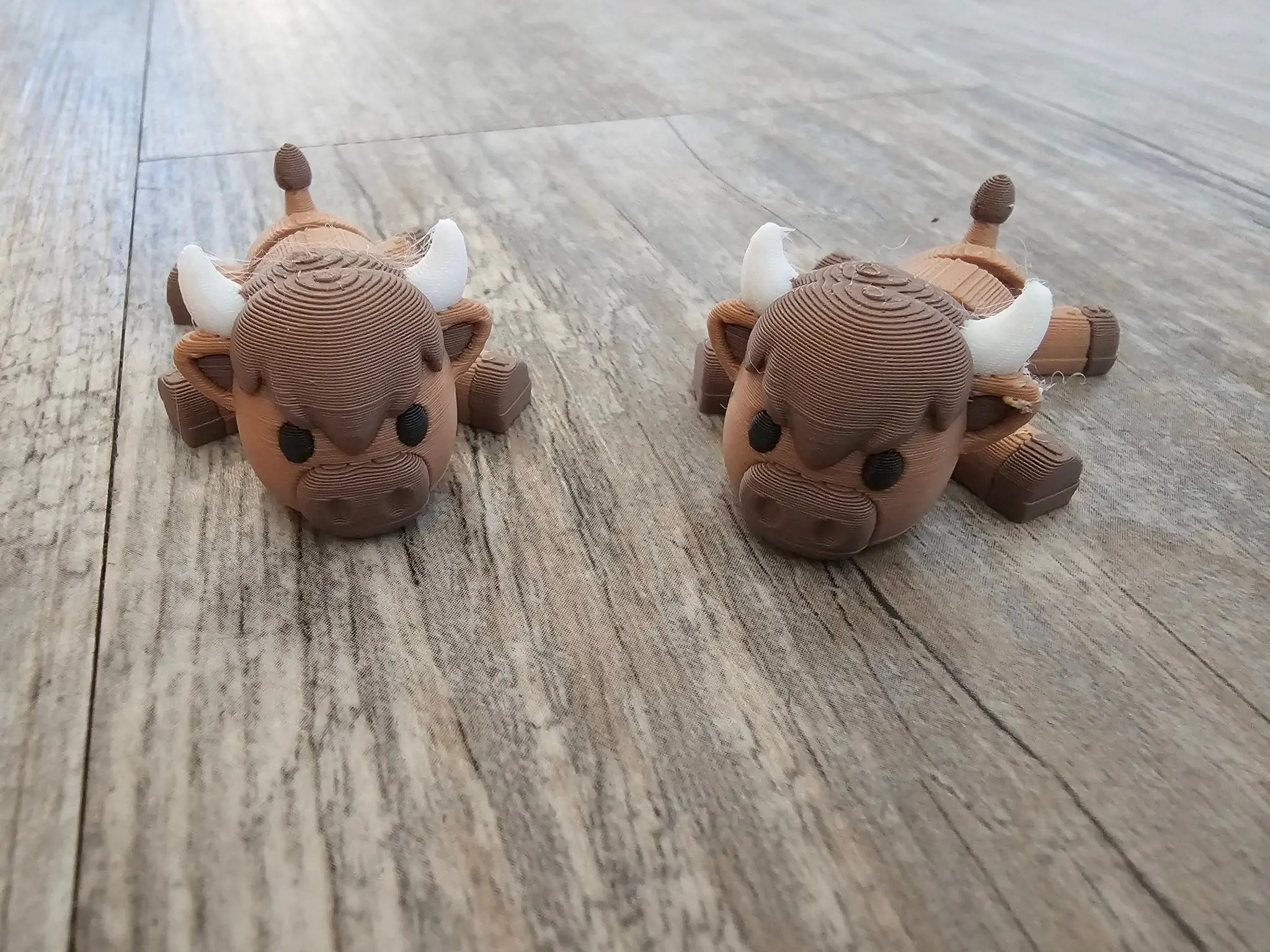 Two cute 3D printed animal figurines - cows or bulls - handmade fidget toys from Main Street Collective. Desk pets for kids & adults!
