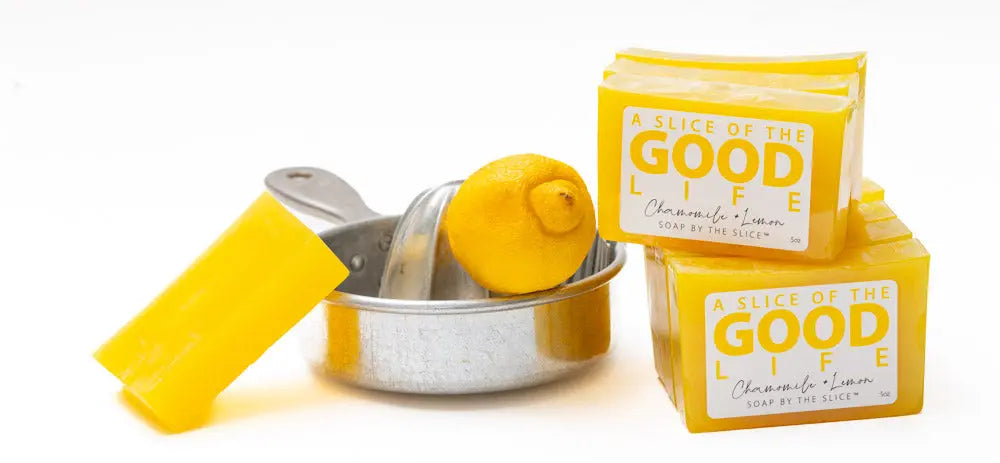 Yellow "A Slice of the Good Life" chamomile lemon soap bars with a lemon and juicer.