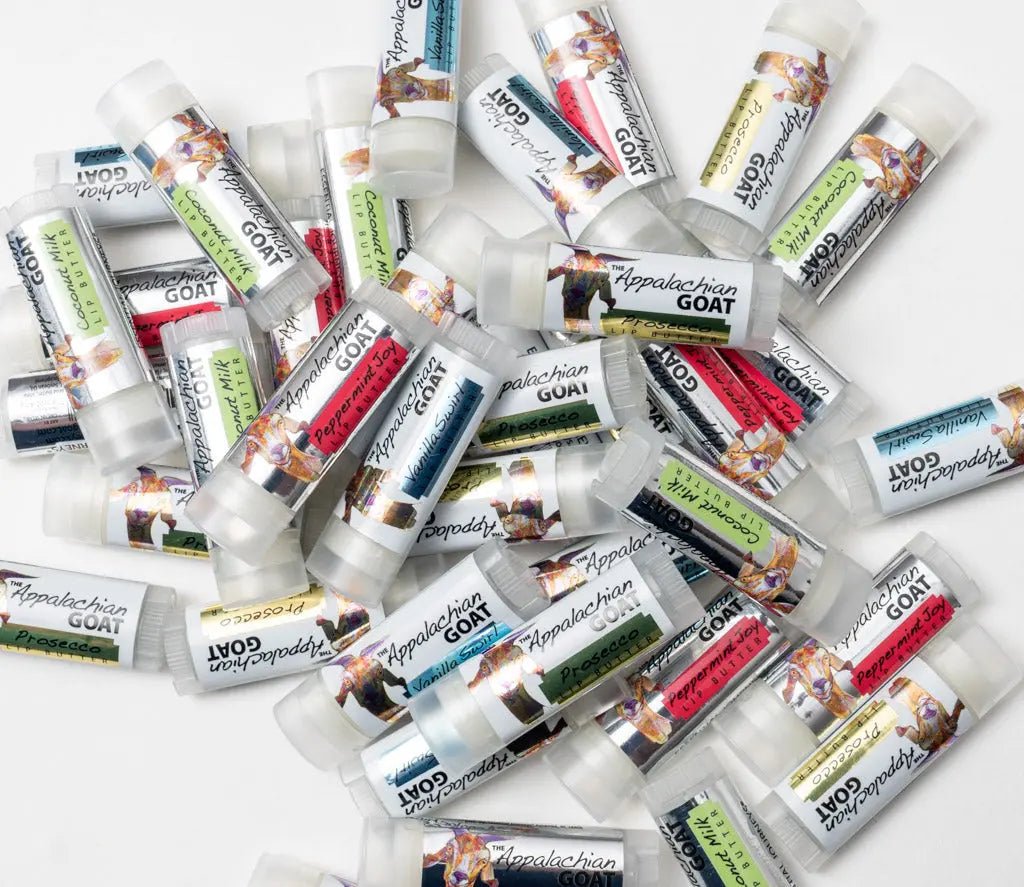 Pile of Appalachian Goat lip balm tubes in Coconut Milk and other flavors.