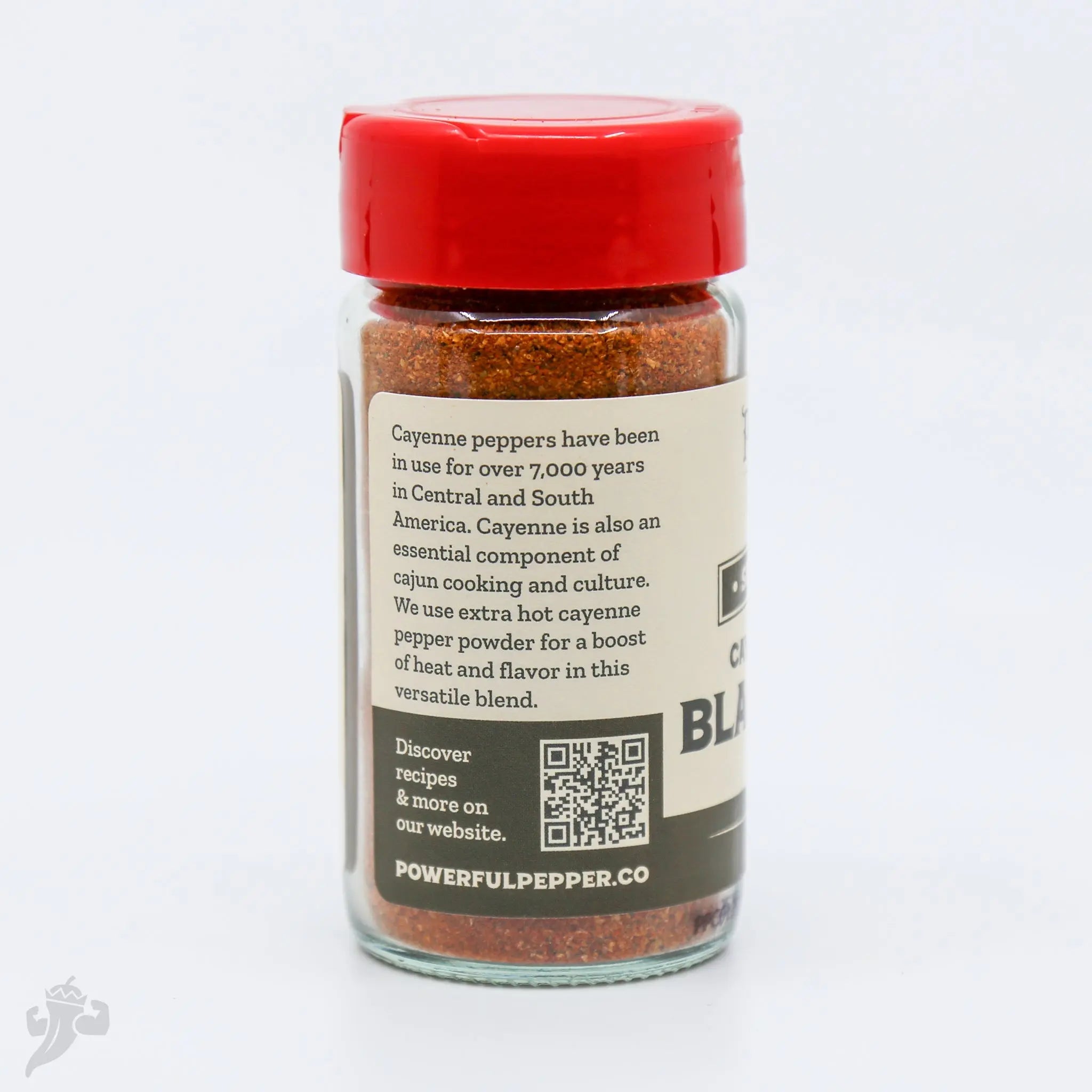 Cajun Blackening Seasoning spice blend in a clear glass jar with a red lid from Powerful Pepper Company.