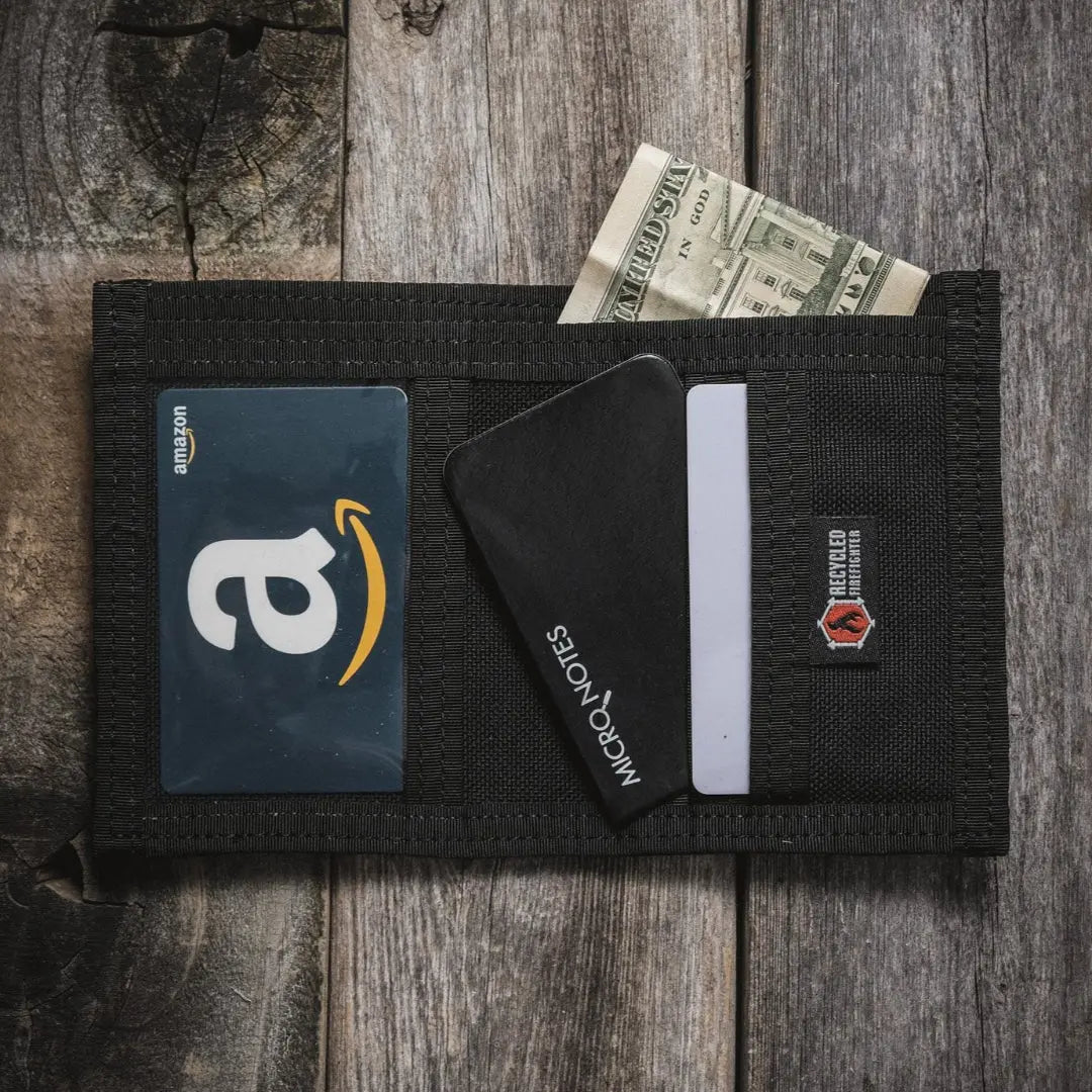 Black fabric wallet with Amazon gift card, Micro Notes card, cash, and Recycled Firefighter logo.