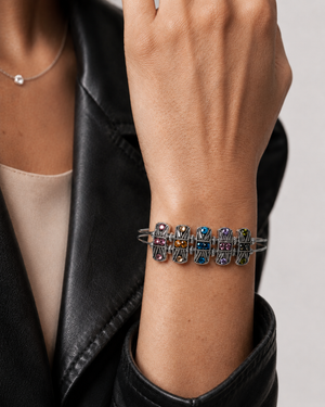 Multicolored beaded bracelet on a wrist with a black leather jacket background