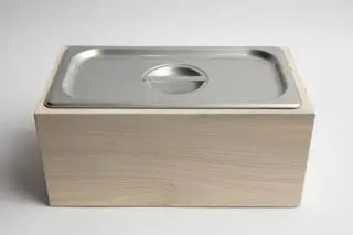 Magnolia wood countertop compost bin with stainless steel pan and lid, designed for kitchen compost and waste reduction.