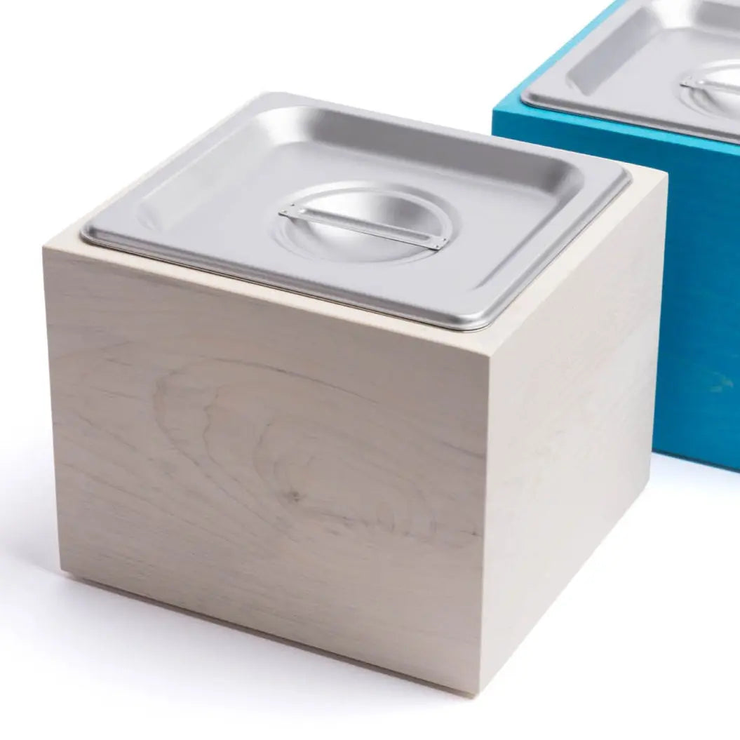 Magnolia wood countertop compost bin with stainless steel insert and lid.