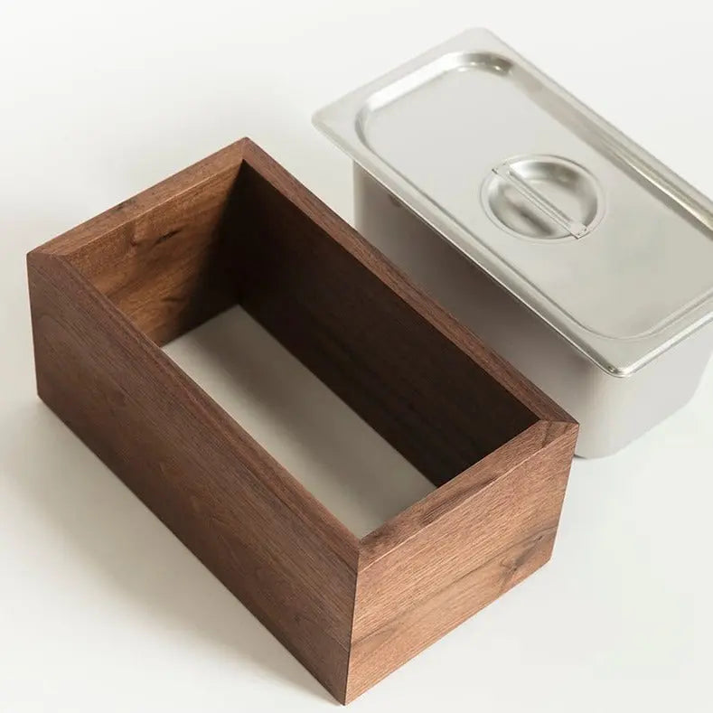 Walnut wood compost bin with stainless steel insert and lid for kitchen waste.