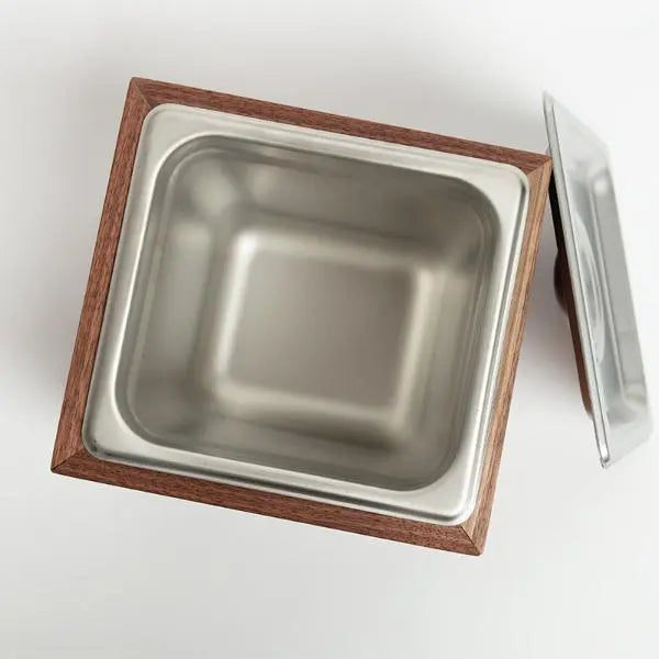 Square compost bin with walnut wood frame, stainless steel interior, and a lid on a white background.