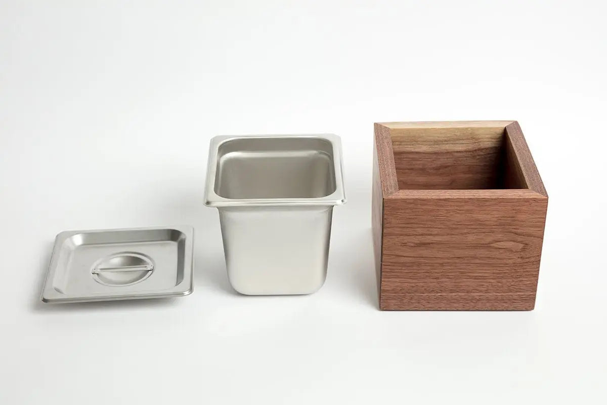 Countertop compost bin featuring a walnut wood holder, stainless steel bin, and lid on a white background.