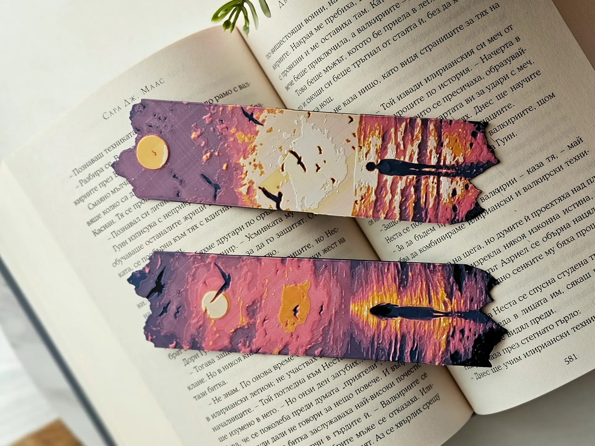 Two textured bookmarks with ocean sunset scenes in pink, purple, and gold colors.