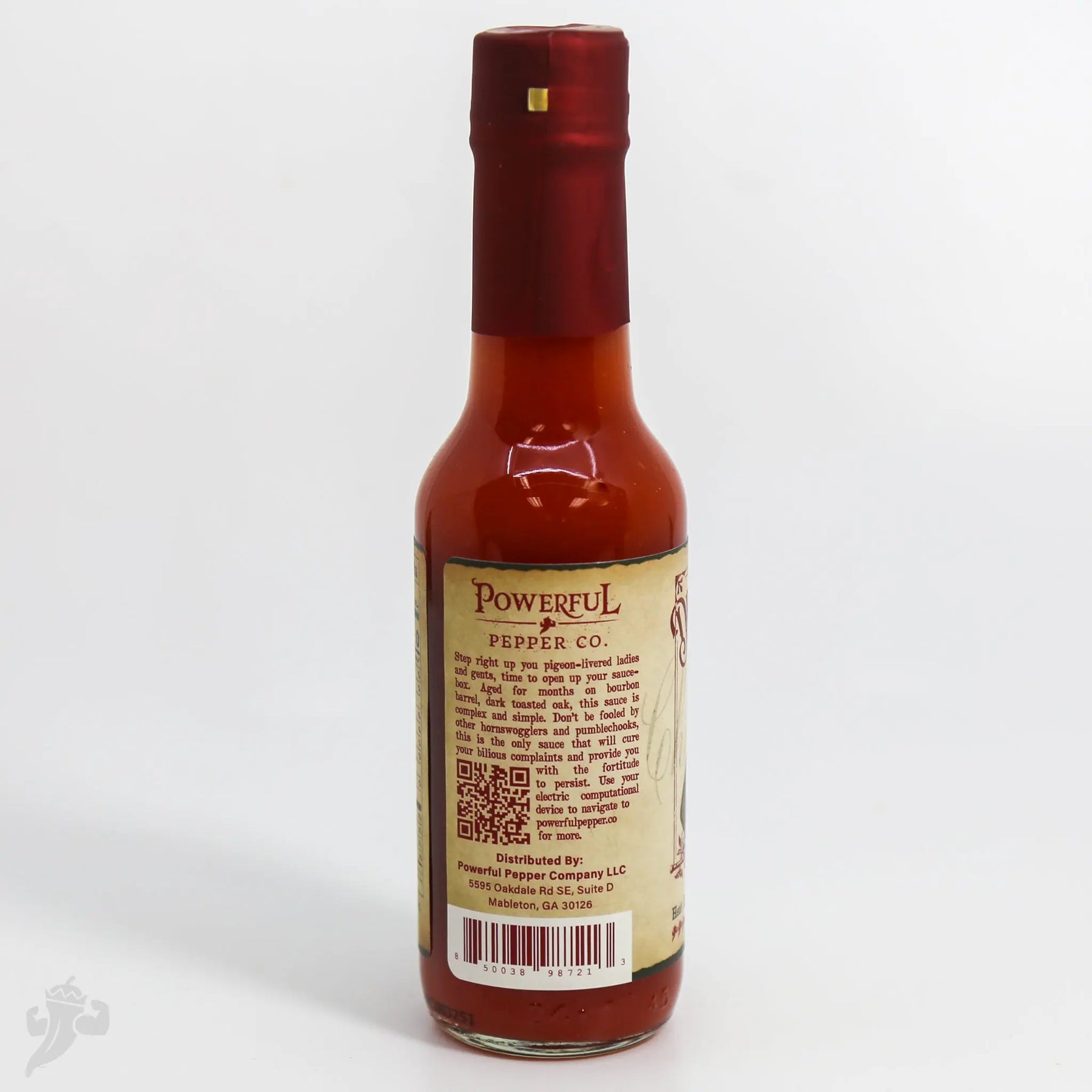 Powerful Pepper Co. barrel-aged hot sauce in a clear glass bottle with a red cap.
