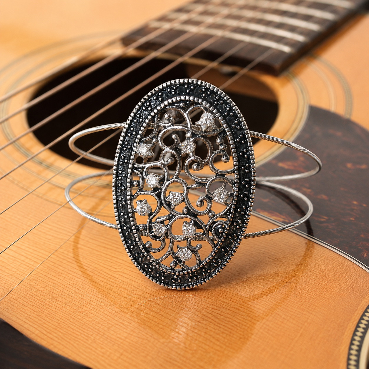 Guitar string bracelet with silver filigree oval