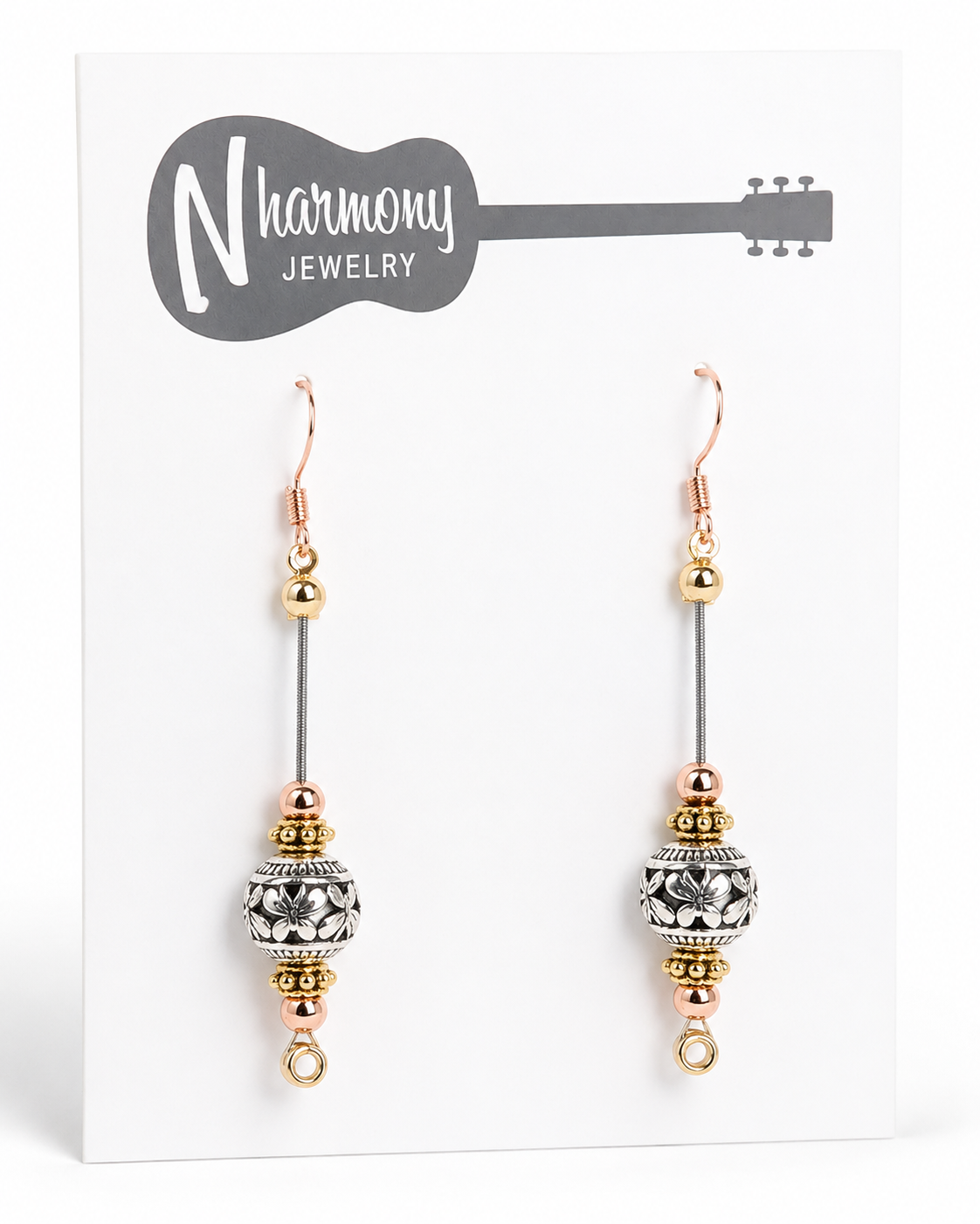 Pair of beaded earrings on a N'Harmony Jewelry card.
