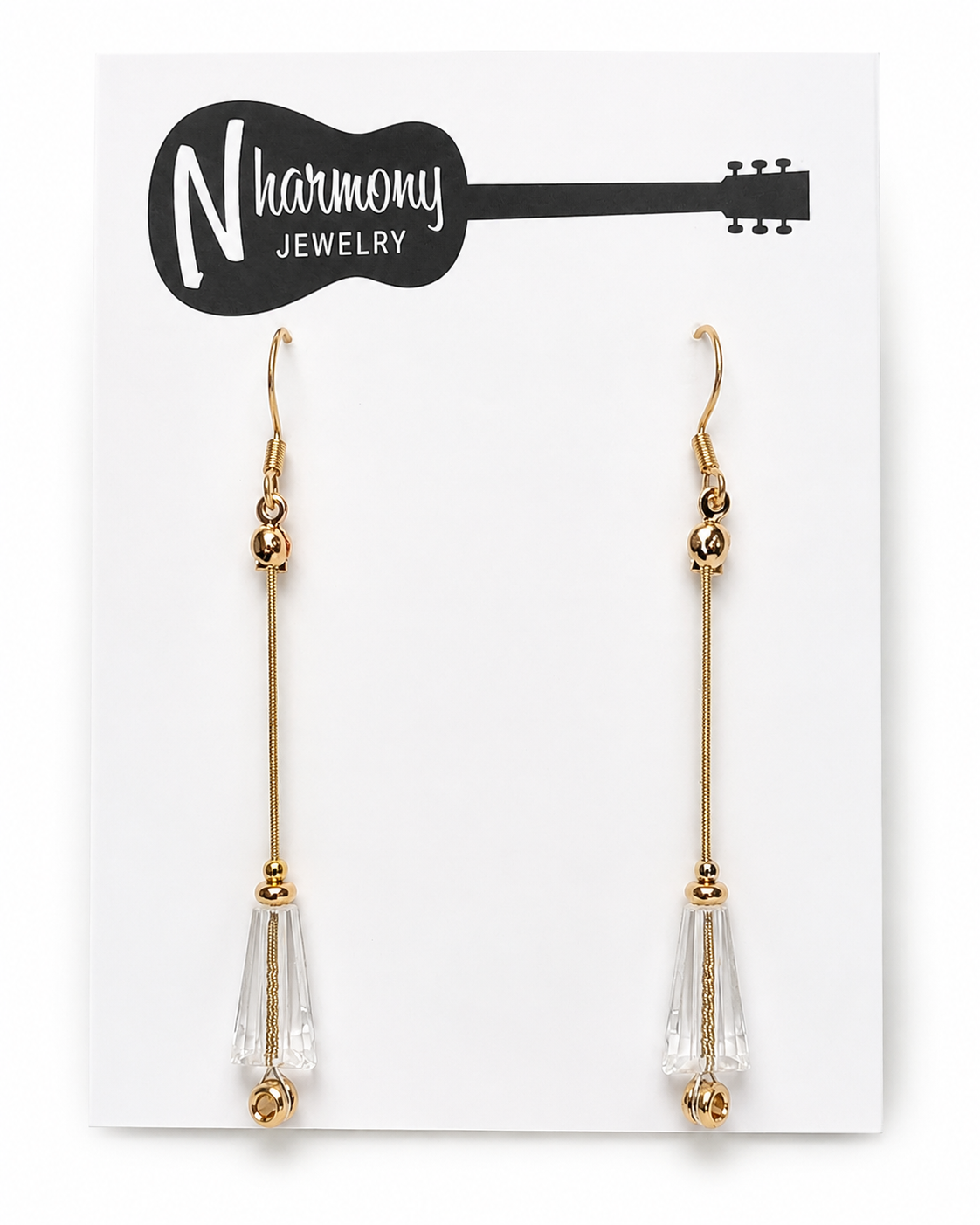 Gold and clear teardrop earrings on a N'Harmony Jewelry card.