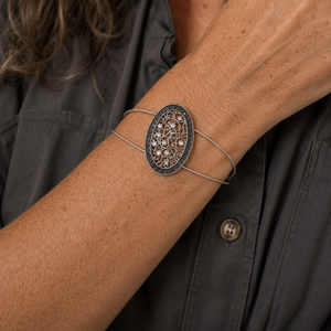 Guitar string bracelet with silver filigree oval