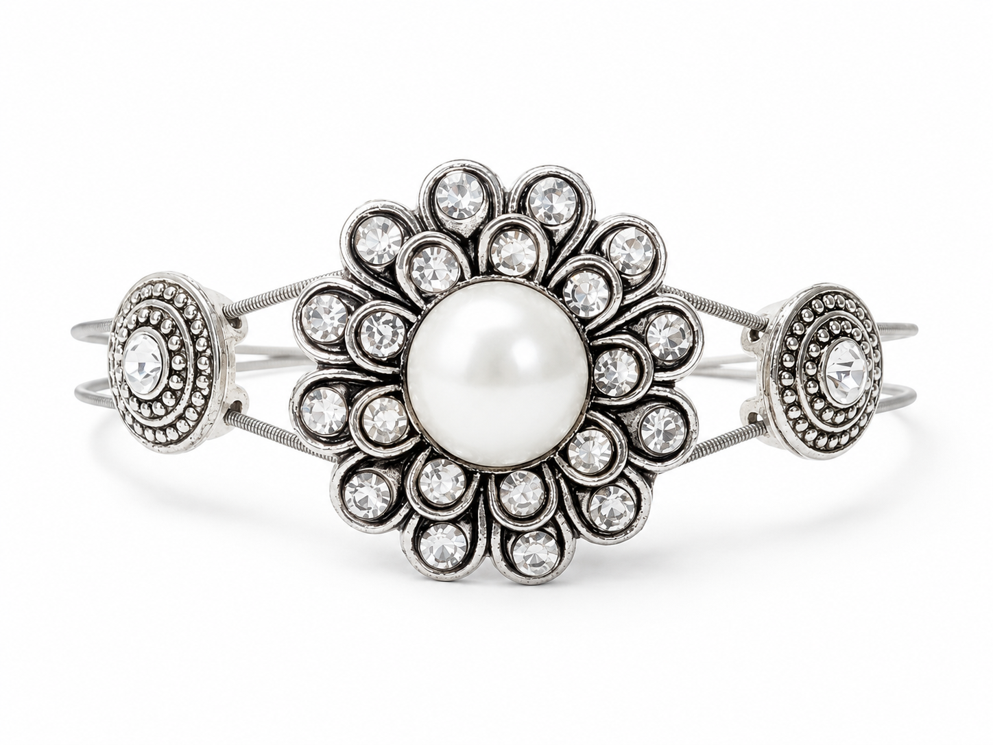 Silver bracelet with a central pearl and decorative elements on a white background