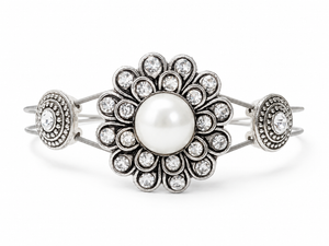 Silver bracelet with a central pearl and decorative elements on a white background
