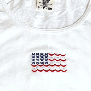 White cotton American flag tank top with embroidered bows.