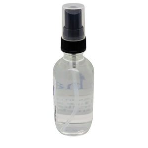 Clear spray bottle with black nozzle and cap, partially visible label with clear liquid inside