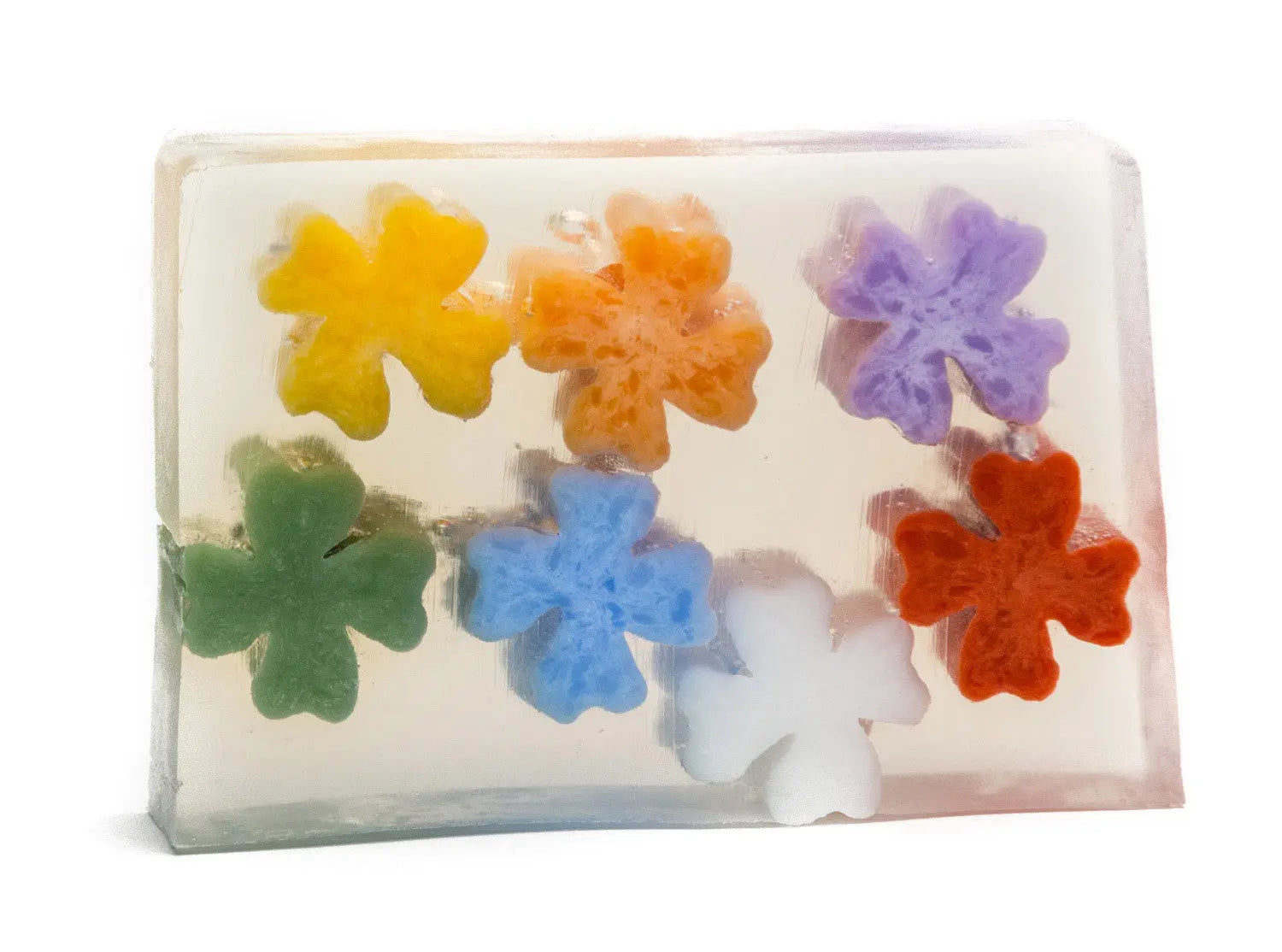 Clear soap bar with colorful flower-shaped embeds in yellow, orange, purple, green, blue, white, and red.