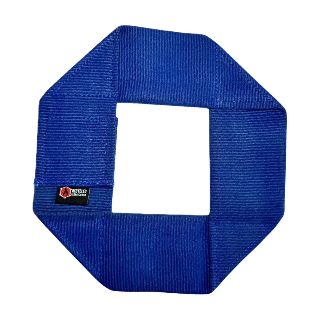 Blue octagon-shaped fire hose dog frisbee with a white center and a "Recycled Firefighter" tag.