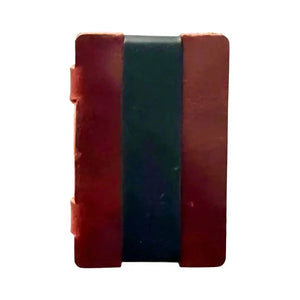 Full grain leather card wallet with red covers and a black strap.
