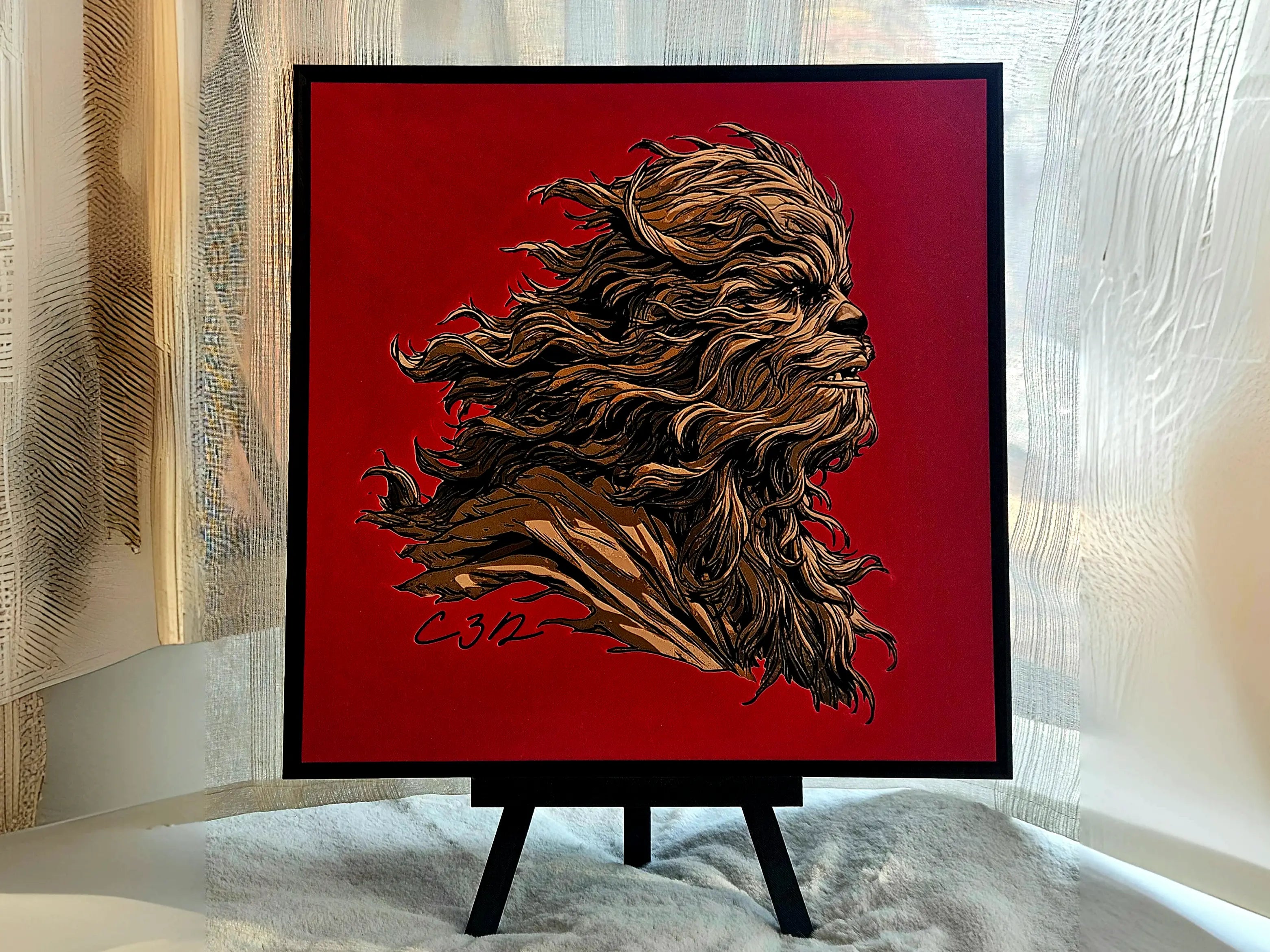 Chewbacca-inspired portrait on a desk easel. Sci-fi wall art of a Wookiee-like character in brown on a red background, signed C312.