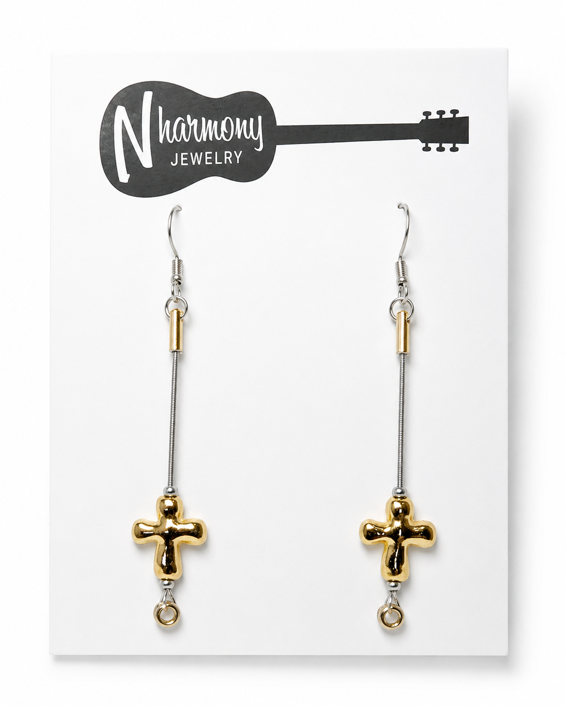 Gold cross earrings on a 'Harmony Jewelry' card
