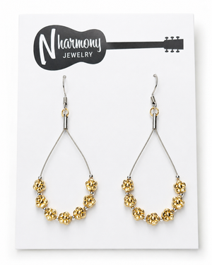 Gold beaded earrings on a NHarmony Jewelry card