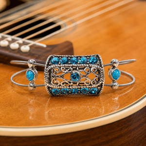 Silver bracelet with blue stones on a guitar