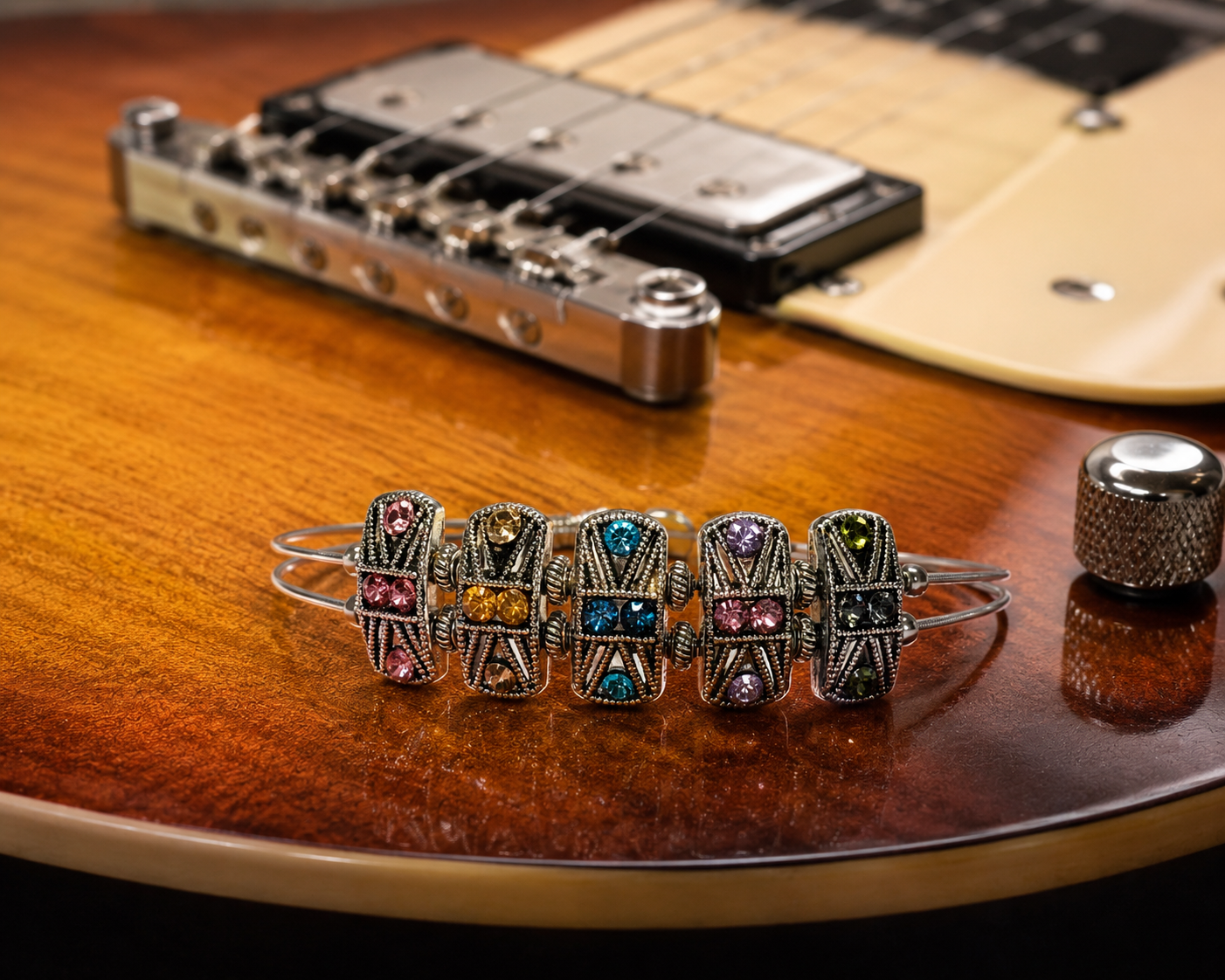 Decorative bracelet with colorful stones on a guitar