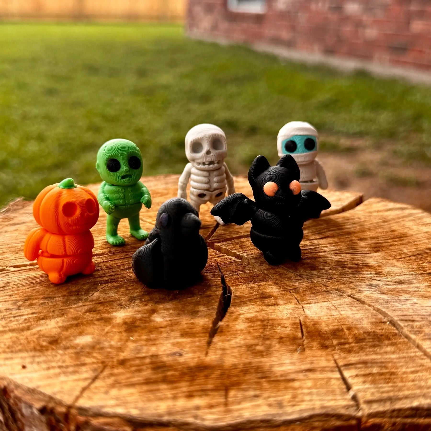 Halloween Fidget Toys: 3D Printed Pumpkin, Zombie, Skeleton, Mummy, Bat, & Crow Figurines on Wooden Log by Main Street Collective