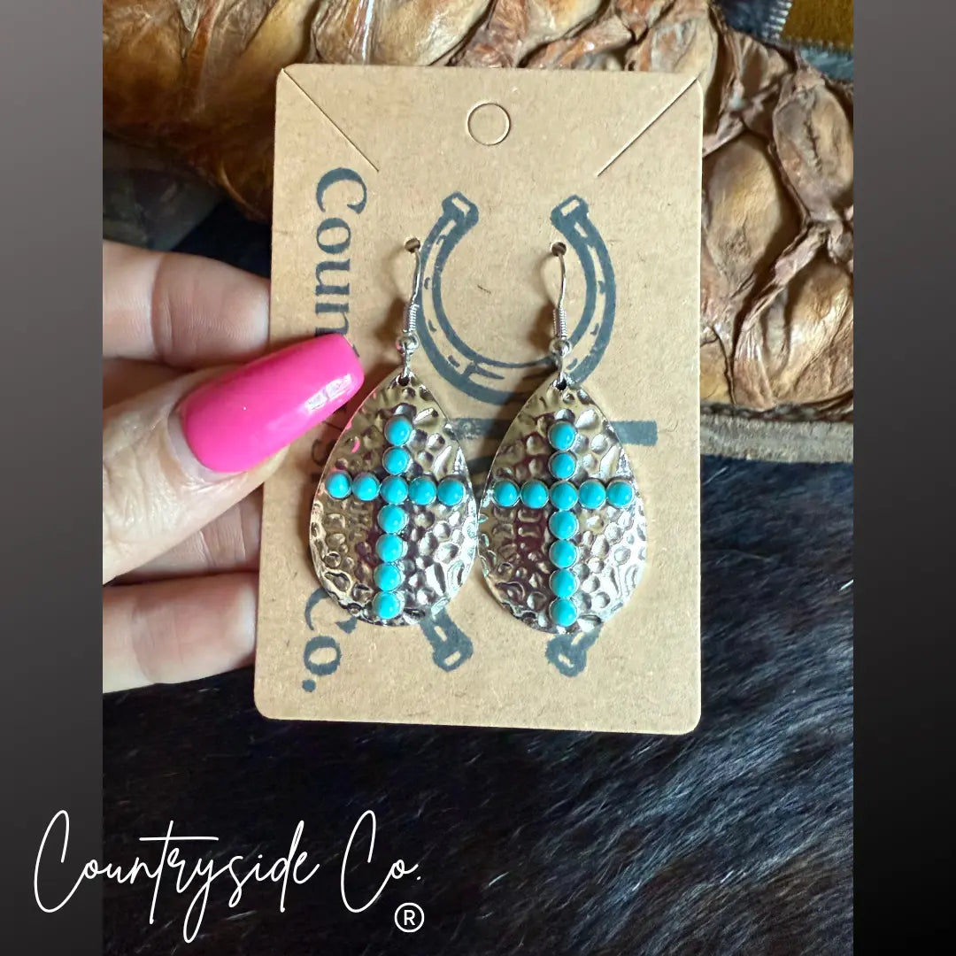 Hammered silver cross earrings with turquoise stones.